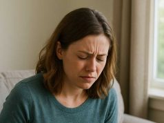 A person sitting at home researching abdominal pain
